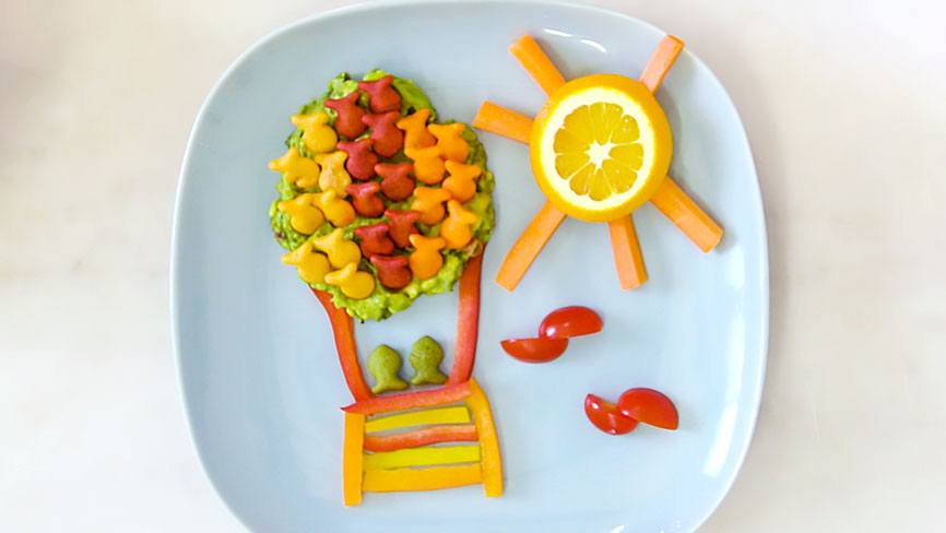 Goldfish® Crackers used as artwork showing sun and hot air balloon on blue plate