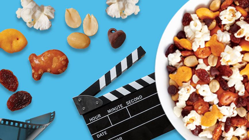 Goldfish® Best Movie Night Mix in a bowl with film strip and film clapboard on blue background