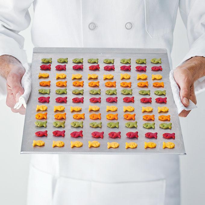 Chef holding Goldfish® Colours crackers on baking sheet
