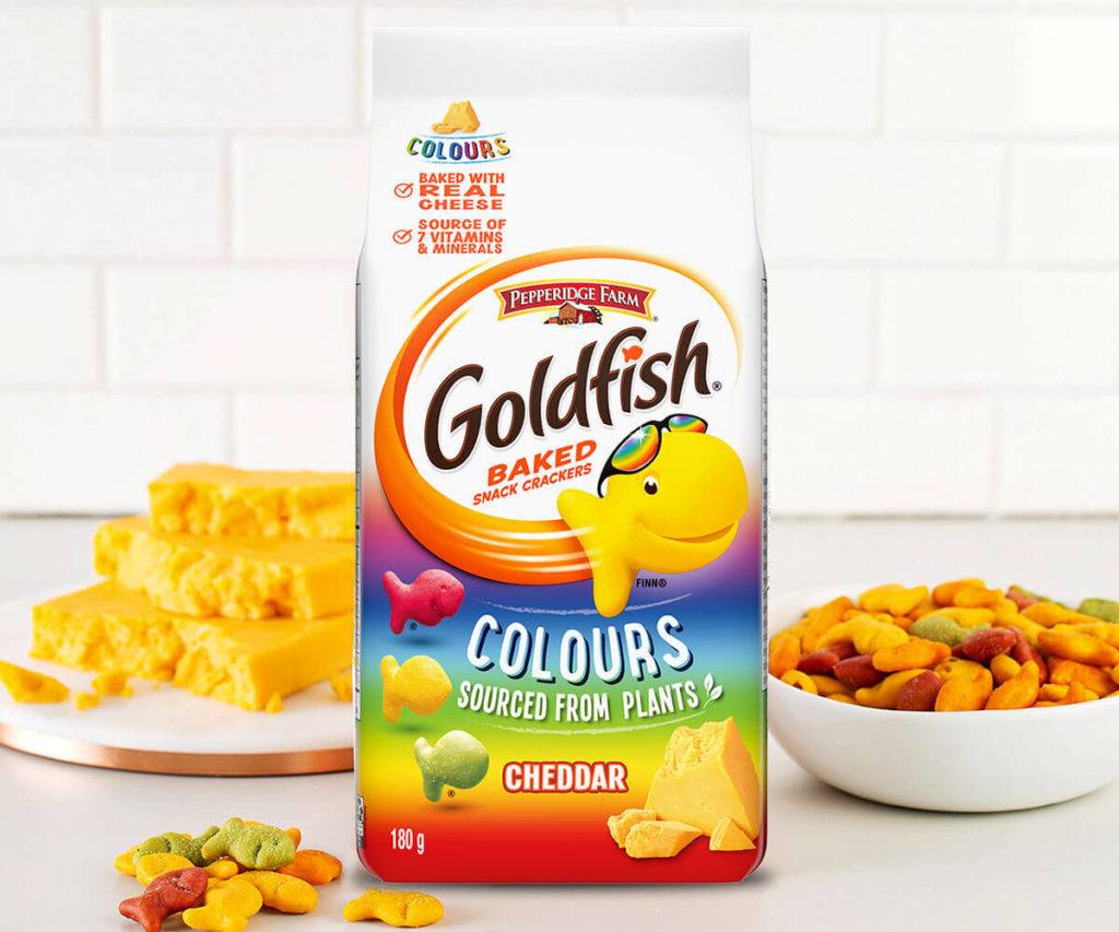 Goldfish® Colours package with cheddar cheese blocks, Goldfish® crackers in bowl and on table